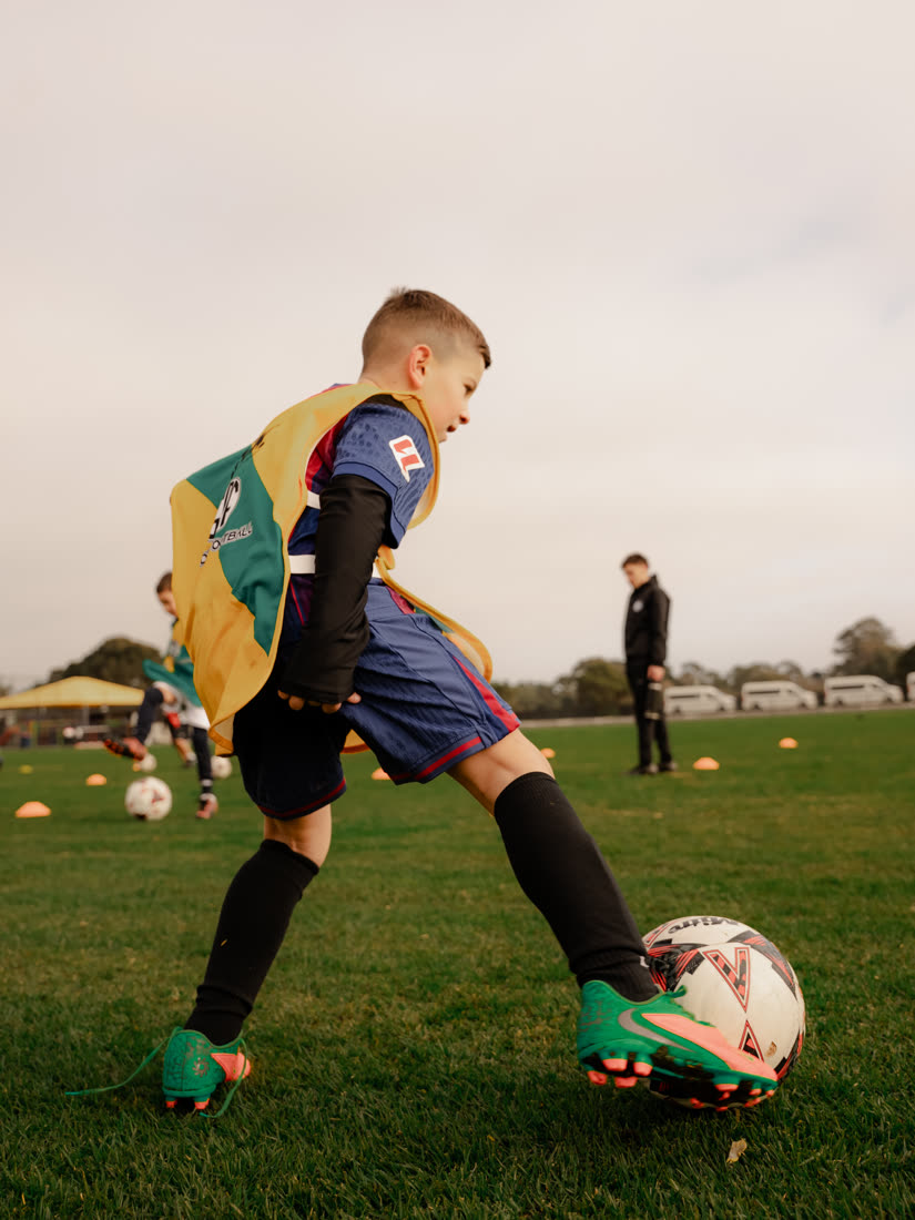 A GDF player dribbling close to the ball