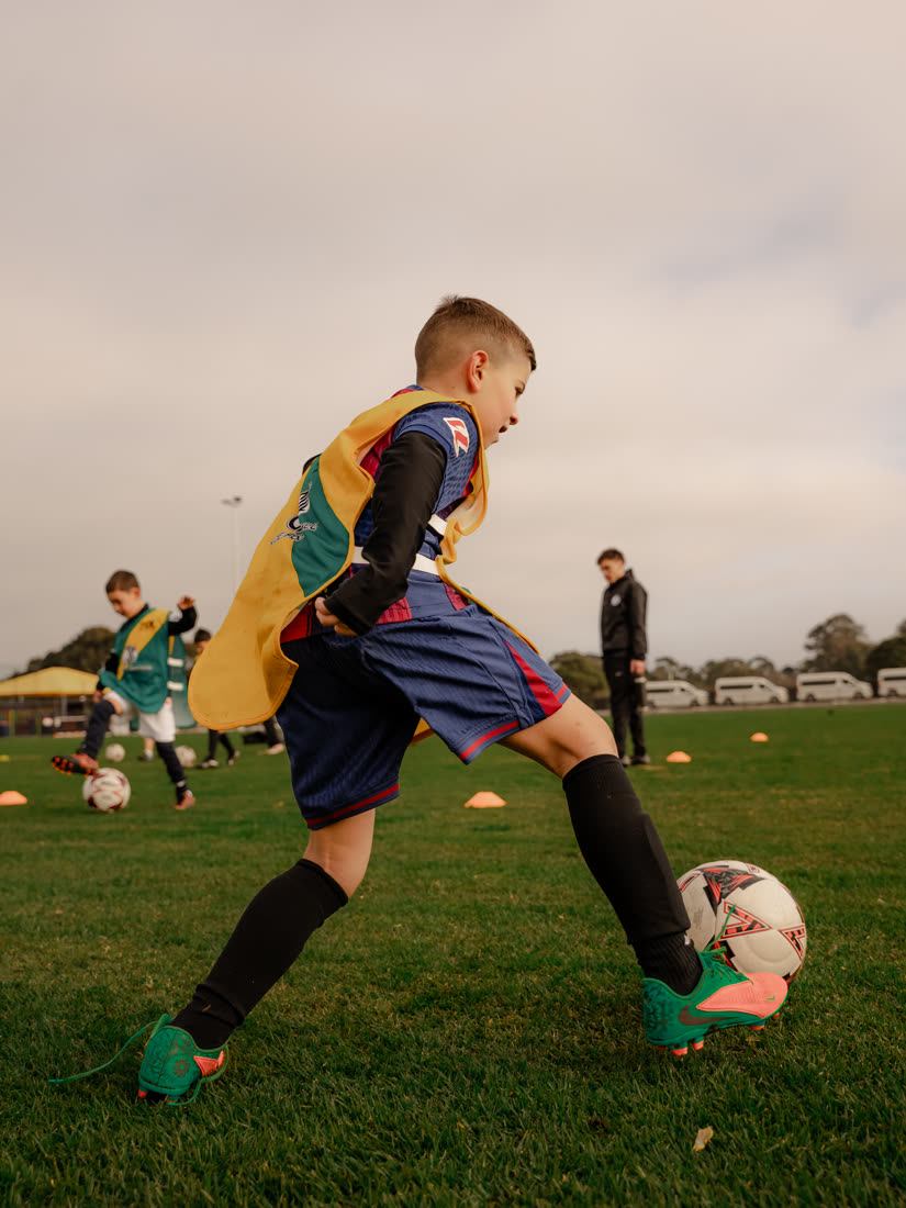 A young player about to strike the ball