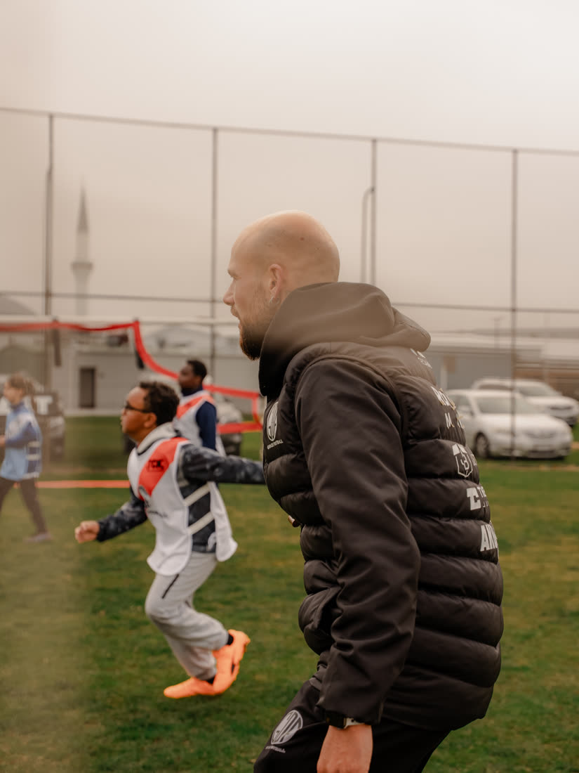 Coach Gavin coaching a young player one on one