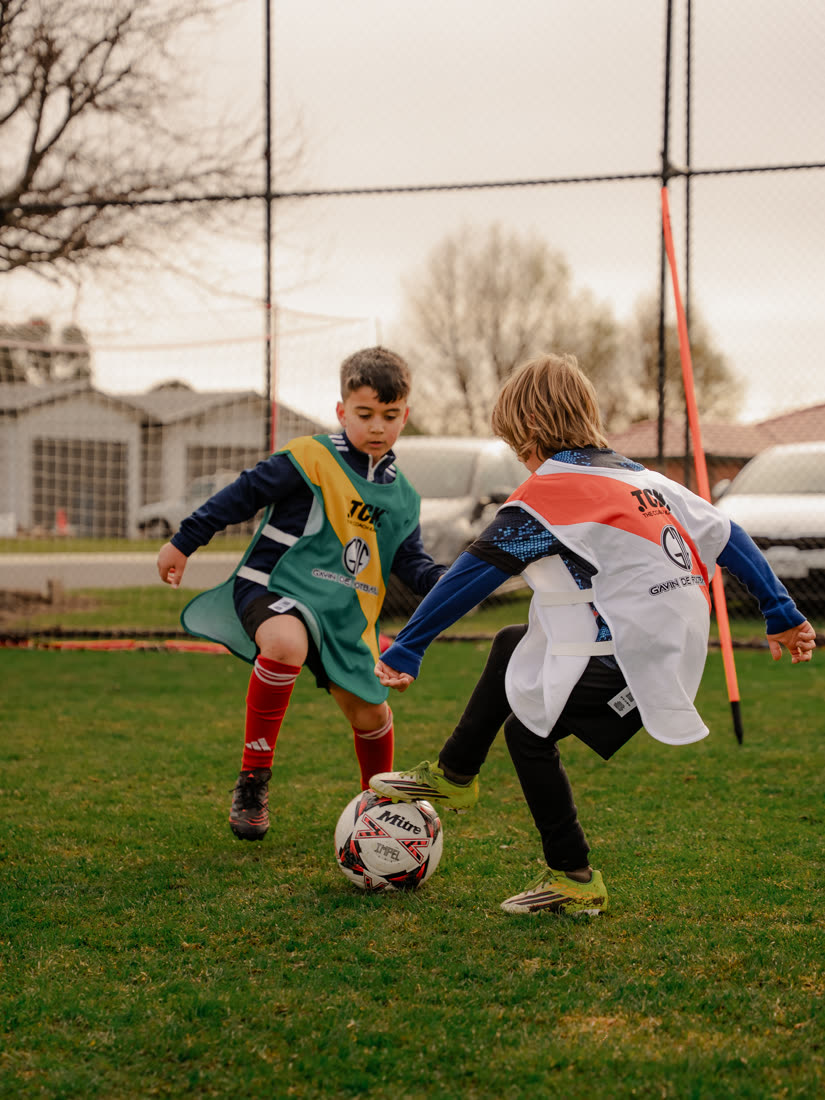 Two young players battling for possession
