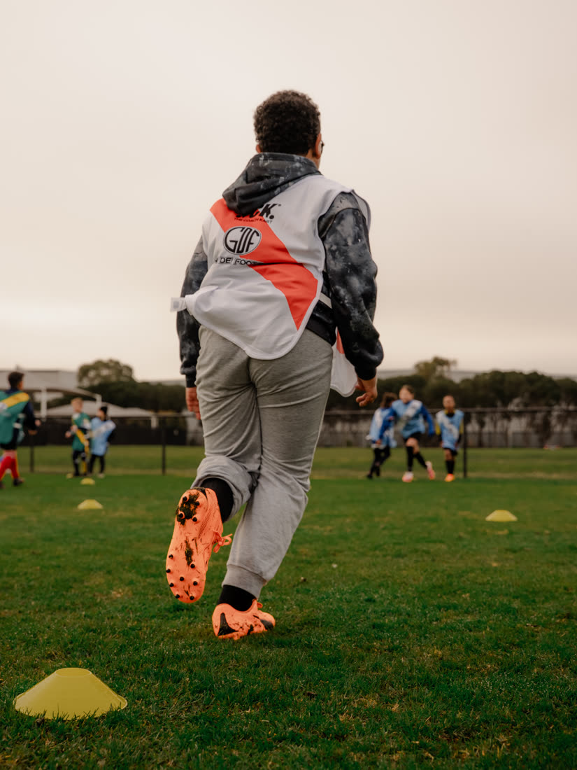 A GDF player striking the ball