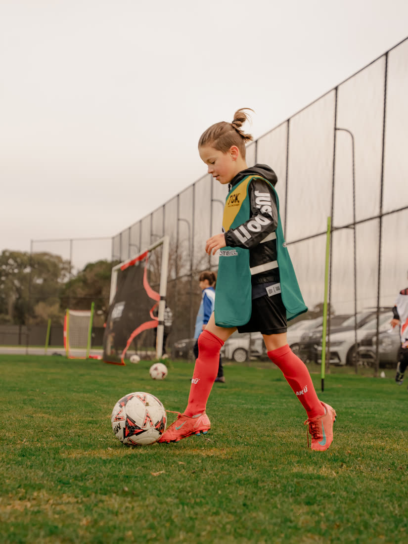 A girl striking the ball at a GDF session