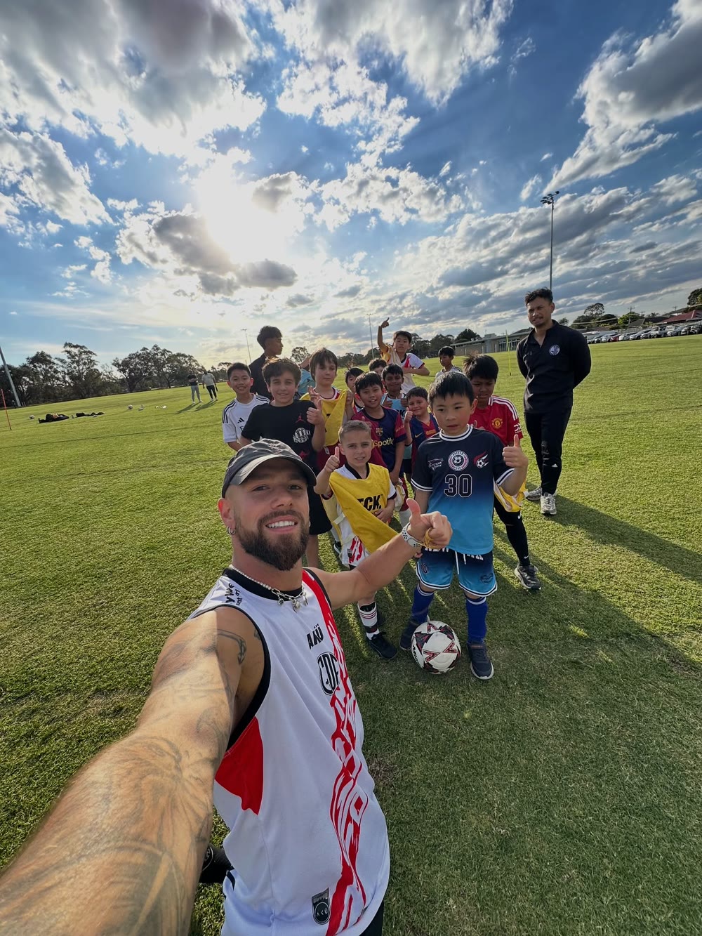GDF players giving a thumbs up with coach Gavin