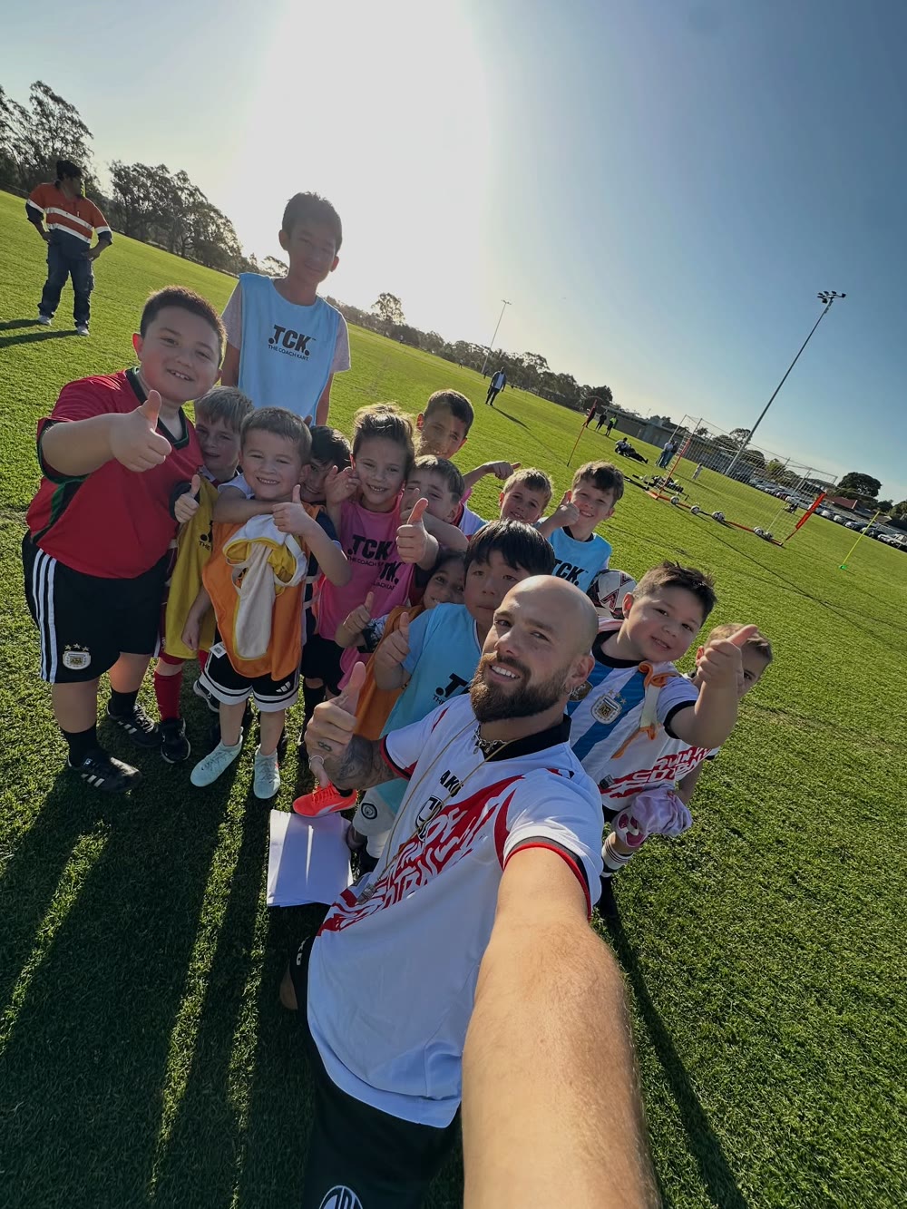 Gavin with a group of young footballers at training