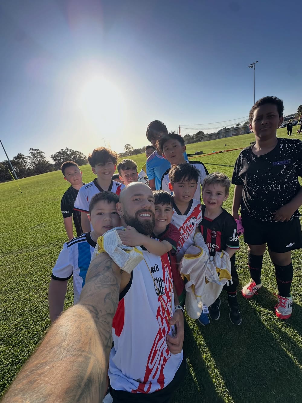 GDF players and coach Gavin together on the pitch