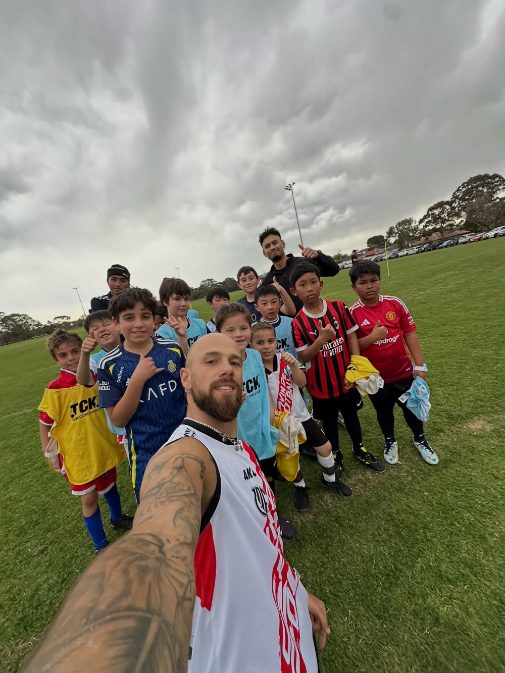 Coach Gavin de Niese with smiling GDF players